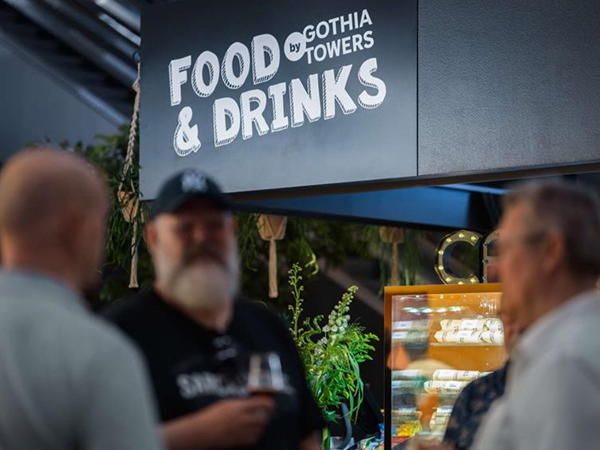 Food & Drinks area with visitors at an exhibition.